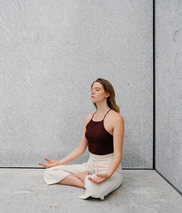 Person meditating outdoors, representing mental clarity and focus.